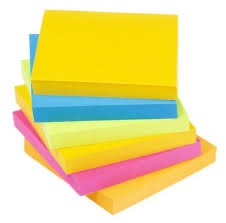 Stack of colorful Post-it notes in yellow, blue, pink, and green for study reminders.